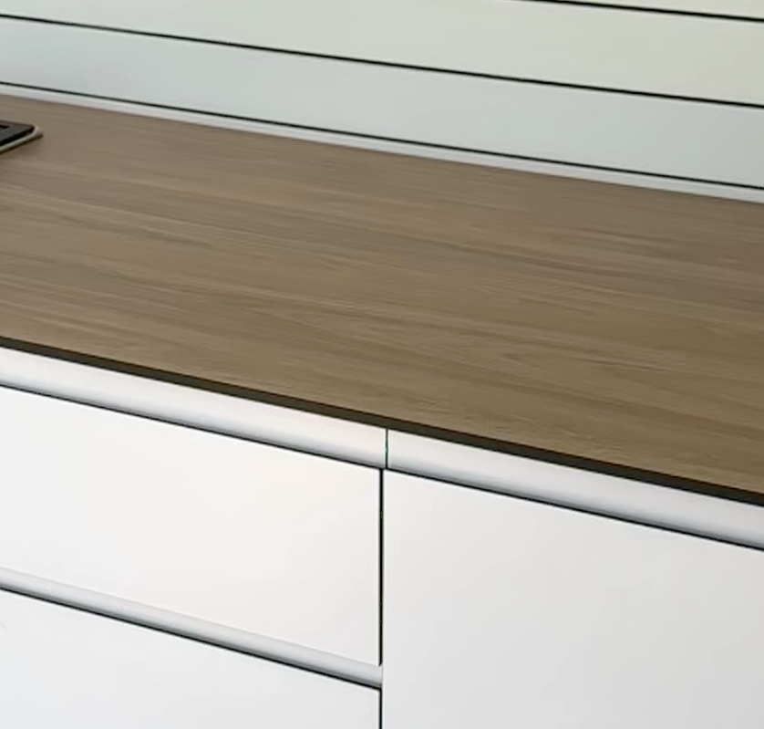 Close view of outdoor kitchen cabinet doors and a finger-pull profile.